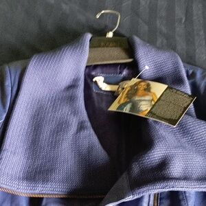 Women's Cobalt blue, knee-length trench leather coat designed by Iman. Stylish.